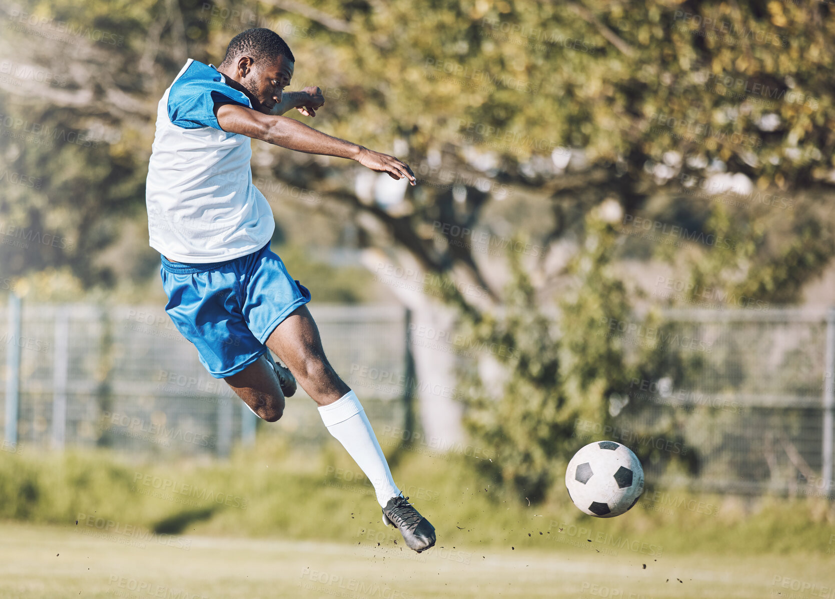 Buy stock photo Sports, soccer and man in action with ball playing game, training and exercise on outdoor field. Fitness, workout and male football player kicking, running and score goals, winning and competition