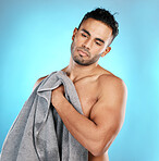 Shower, towel and man isolated on blue background for skincare, beauty and body wellness with mockup space. Washing, hygiene and cleaning model or young person in studio for dermatology or self care