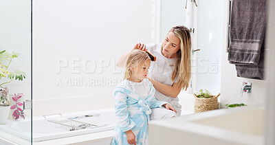 Buy stock photo Morning, mother and daughter in bathroom with hair brush for grooming care routine in family home. Motherhood, child and mama brushing hair of young kid in house and getting ready for the day.