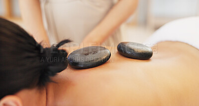 Buy stock photo Woman, spa and back with hot stone in closeup, massage or care for professional treatment, muscle and wellness. Girl, masseuse or rock for physical therapy, spine and health at luxury resort for body