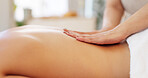 Therapy, spa and woman relax with massage for healthcare, muscle tension and wellness at luxury therapist. Hands, zen and body treatment for calm patient or customer on a bed for physical therapy