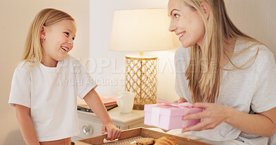 Breakfast, child and mama with a gift on mothers day in the morning to celebrate her mommy at home. Smile, Love and happy girl giving parent a present box and a croissant with cookies in a bedroom