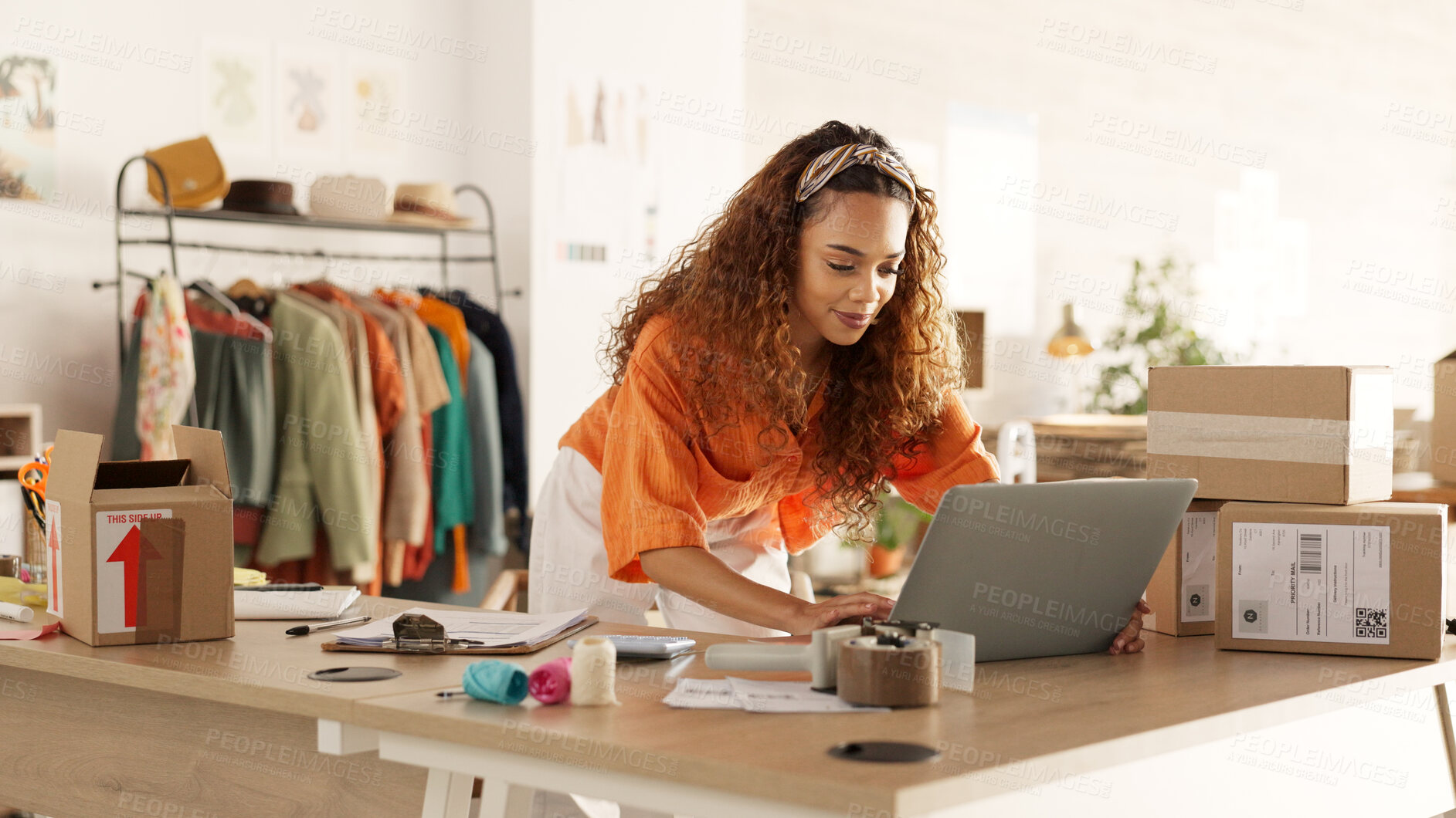 Buy stock photo Woman, typing and laptop with boxes, logistics or e commerce for stock, boutique or order at startup. Designer, computer and reading for supply chain, store and cardboard package for delivery on desk