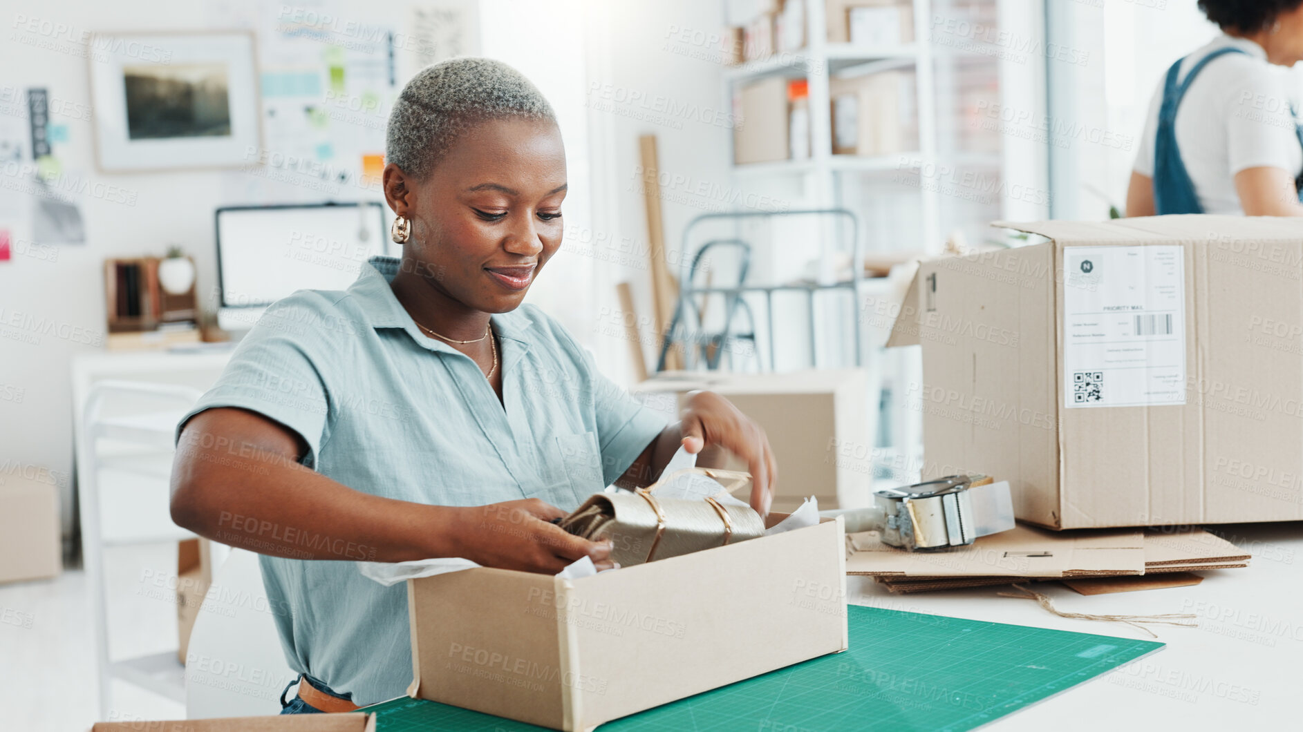 Buy stock photo Ecommerce, black woman packing boxes in office for sales and delivery, seller at creative startup with smile. Online shopping, package and small business owner with product, stock or retail web store