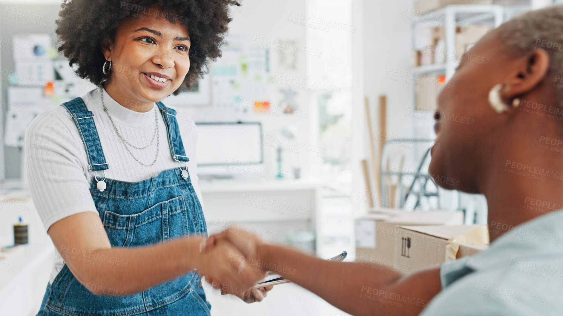 Buy stock photo Fashion designer shaking hands with a partner in a meeting for success, teamwork or business deal together. Happy manager, smile or b2b handshake for ecommerce sales goal or shipping product in boxes