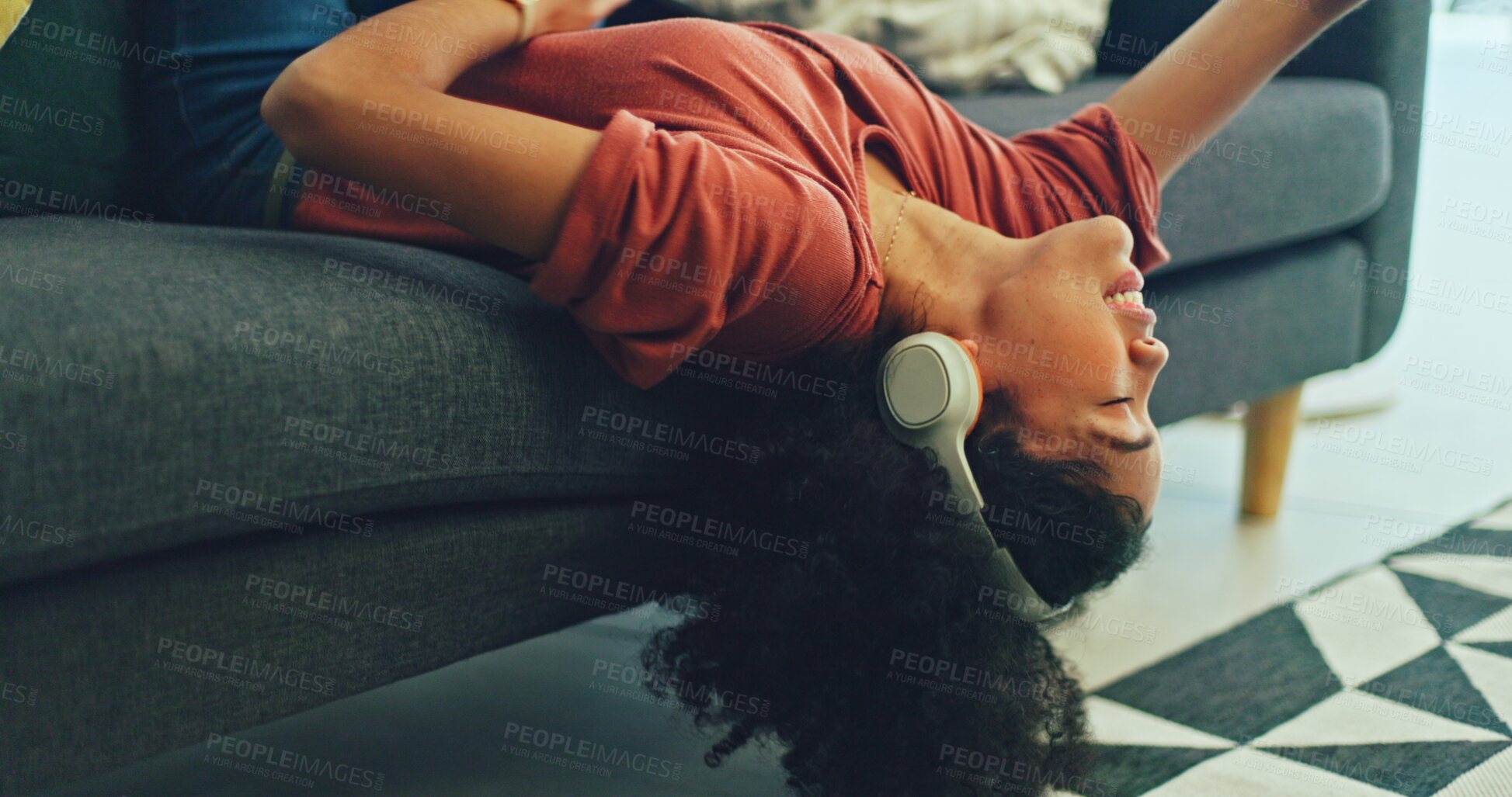 Buy stock photo Woman lying on sofa with music, singing in living room, relax with streaming radio service. Headphones, energy and girl on couch in lounge listening to audio with internet, technology and freedom.