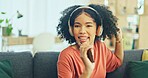 Black woman, dancing and headphones on sofa, being content and singing words in living room. Young girl, headset and digital device for contemporary dancer, moving with rhythm and relax on break.