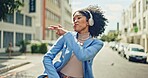 Music, street and black woman dance with energy, wellness and freedom while streaming rap, hip hop or radio sound. Headphones, crazy fun and retro dancer listening to audio song while dancing in city