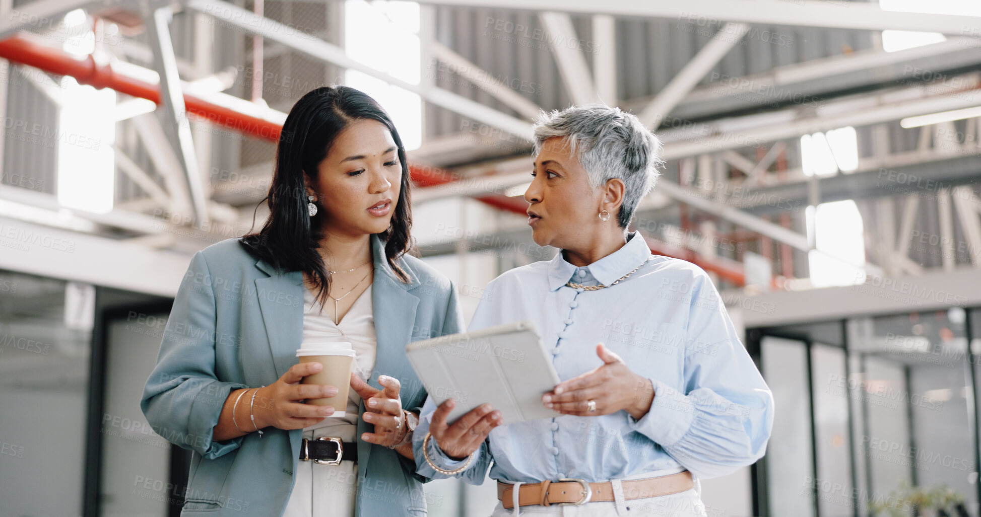 Buy stock photo Business, tablet and mature woman with employee, talking and walking in modern office. Women, female administrator and manager speaking, conversation for schedule and leader in workplace or corporate