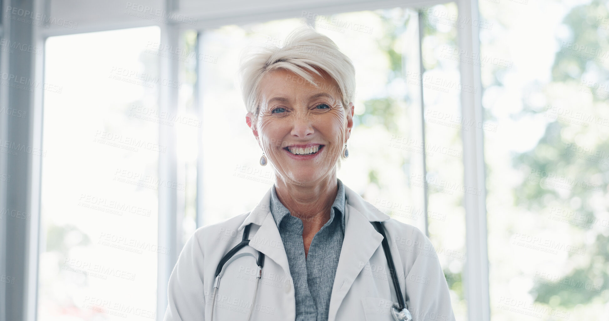 Buy stock photo Happy, doctor and portrait of senior woman in hospital, friendly and confident about healthcare service. Face, smile and lady health expert with stethoscope at clinic for help, trust or guidance