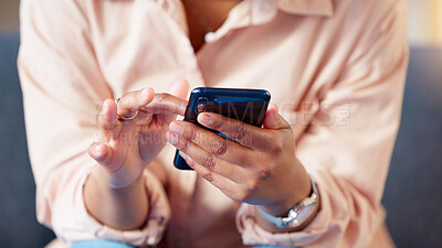 Closeup of hands texting on phone, typing social media post and searching or scrolling online. Relaxed woman sitting alone on home living room sofa and networking and browsing internet on technology