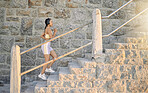Fitness, podcast or woman running on steps for cardio workout, training or body exercise at sunrise in summer. Brazil, wellness or girl athlete exercising or walking on stairs streaming radio music