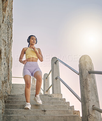 Buy stock photo Fitness, podcast or woman running on steps for cardio workout, training or body exercise at sunrise in summer. Brazil, wellness or girl athlete exercising or walking on stairs streaming radio music