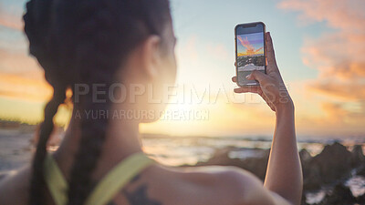 Buy stock photo Beach, phone and woman taking photo of sunset for social media during evening workout in Bali. Nature, ocean and fitness influencer with picture of sun in blue sky on smartphone screen in Indonesia.