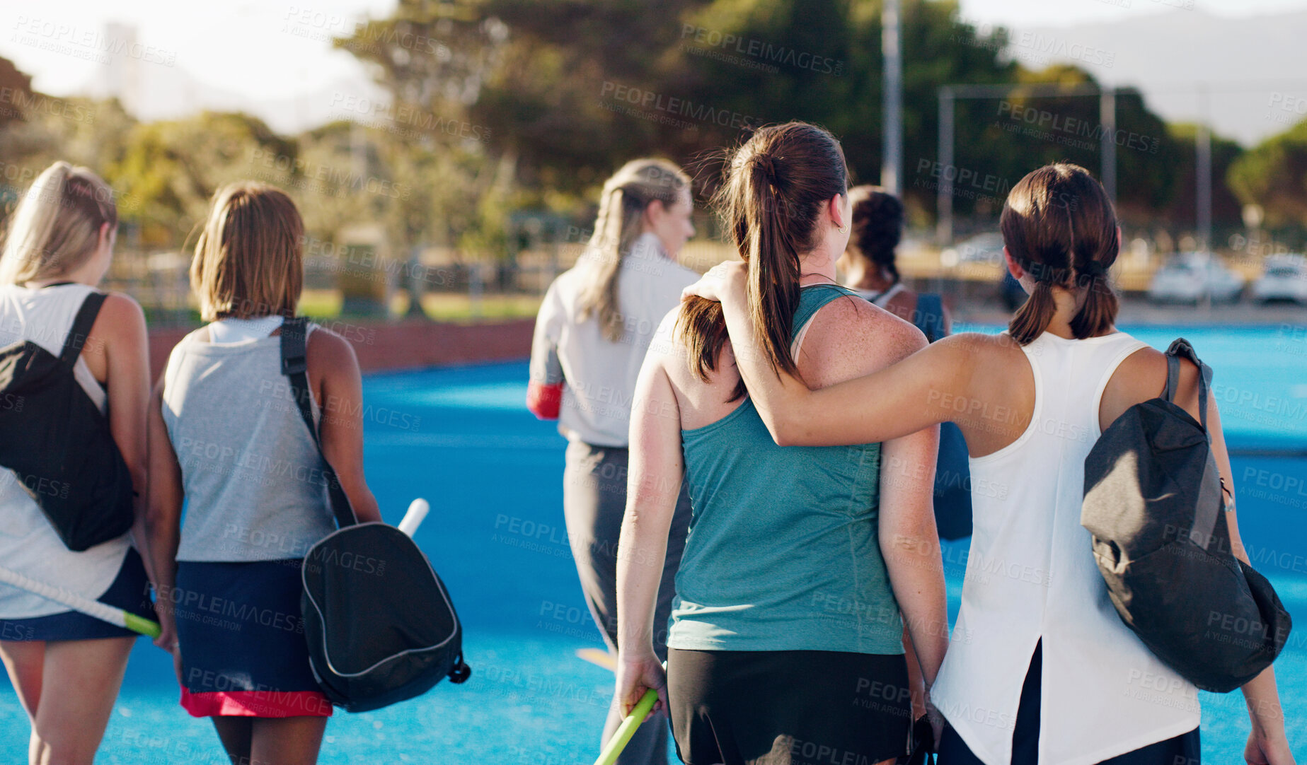 Buy stock photo Women, hockey and teamwork on field together with support, solidarity or walking to fitness training with coach. Sports group, friends and walk from workout, outdoor exercise or hug with conversation