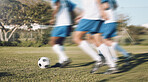 Men, football team and running fast on field with motion blur for training, exercise and teamwork in sunshine. Group, soccer and dribbling together with speed for workout, strategy and sports tactics