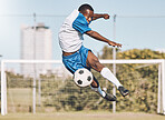 Soccer, action and man jump with ball playing game, training and exercise on outdoor field. Fitness, workout and male football player kicking, running and score goals, winning and sports competition