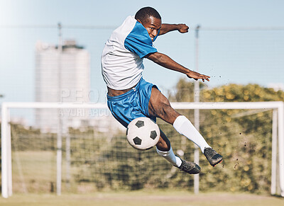 Soccer, action and man jump with ball playing game, training and exercise on outdoor field. Fitness, workout and male football player kicking, running and score goals, winning and sports competition