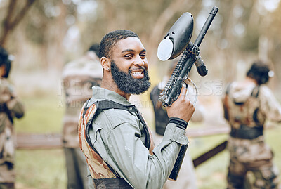 Buy stock photo Sports, paintball and portrait of black man with gun ready for game, arena match and shooting battle outdoors. Smile, adventure and male with weapon in camouflage, military clothes and action gear