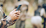 Soldier, hands and phone texting in communication for social media, networking or conversation at war. Hand of person holding mobile smartphone on app in the army for discussion, chatting or contact