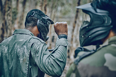 Buy stock photo Hand sign, man and paintball training by friends for planning, strategy and plan of action outdoor. Military, men and fist of guy leading team in sports, shooting and intense target practice together