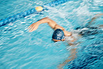 Man, speed or freestyle stroke in swimming pool cap for sports wellness, training or exercise for body healthcare. Workout, fitness and swimmer athlete in motion blur for water competition challenge