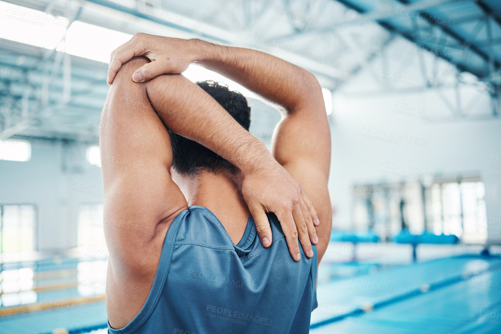 Buy stock photo Rear view, man and stretching at swimming pool for training, cardio and exercise, indoor and flexible. Hand, back and swimmer stretch before workout, swim and fitness routine, warm up and preparation