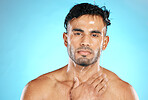 Skincare, portrait and man in studio for water splash, wellness and grooming on blue background. Face, cleaning and guy model relax with luxury, facial and beauty, skin and  routine while isolated 