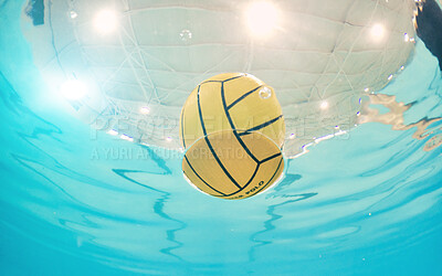 Water polo, sports and ball in a pool from below with equipment floating on the surface during a competitive game. Fitness, training and exercise while a still life object floats during a match