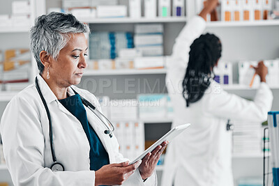 Buy stock photo Pharmacy, inventory and senior woman on digital tablet for checklist, pills and orders. Pharmacist, colleagues and ladies online, internet and search while doing stock at a clinic dispensary together