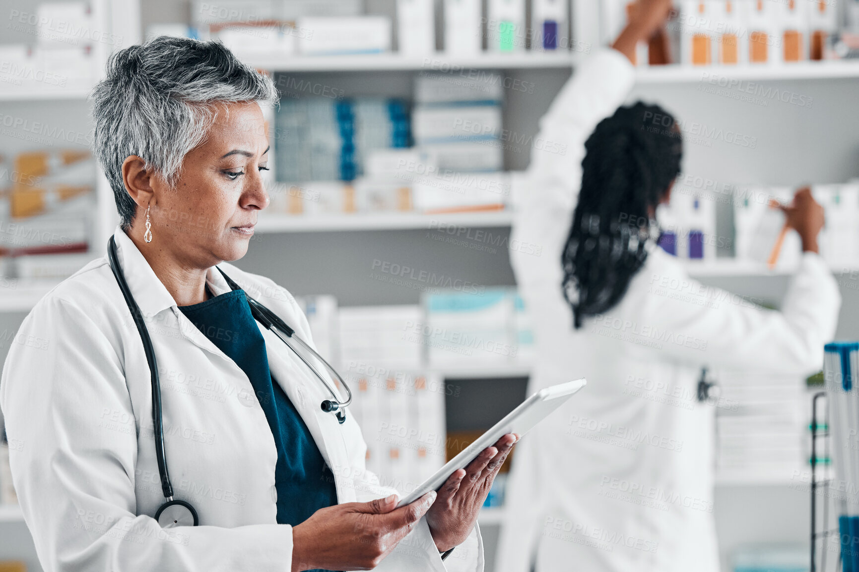 Buy stock photo Pharmacy, inventory and senior woman on digital tablet for checklist, pills and orders. Pharmacist, colleagues and ladies online, internet and search while doing stock at a clinic dispensary together