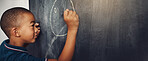 School, chalk and boy drawing on a board for child development, creativity and art for learning. Academic, creative and young kid student writing on a blackboard in the classroom with mockup space.