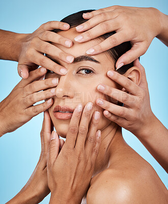 Buy stock photo Many hands, touch face and woman in portrait for skincare wellness, cosmetics and care by blue background. Studio, skin health model and facial aesthetic with transformation, natural glow or makeup
