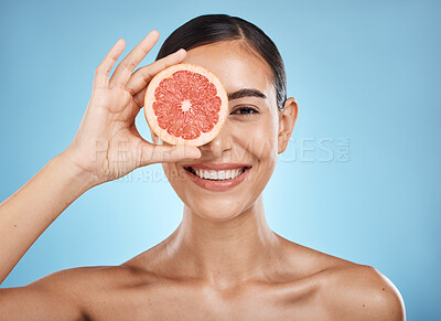 Buy stock photo Beauty, skin care and woman portrait with grapefruit face for dermatology, natural cosmetic and wellness. Happy aesthetic model for sustainable fruit facial, nutrition and glow on blue background