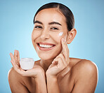 Face cream, skincare portrait and woman with product in studio isolated on a blue background. Cosmetics, dermatology and happy female model with lotion, creme or moisturizer for beauty and wellness.