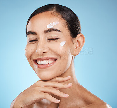 Buy stock photo Beauty cream, skin and face of a happy woman with hand for dermatology, cosmetics and natural glow. Aesthetic model person with natural spa facial self care for health and wellness on blue background