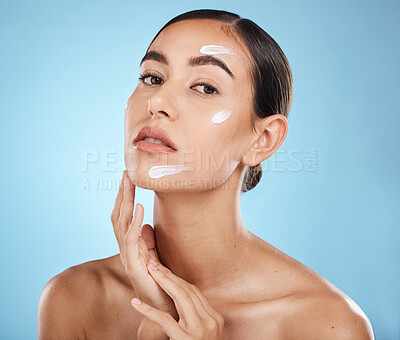 Buy stock photo Skincare cream, face portrait and woman in studio isolated on a blue background. Cosmetics, dermatology and young female model with lotion, creme or moisturizer for beauty, aesthetics and wellness.