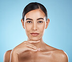 Face, portrait and beauty skincare of woman in studio isolated on a blue background. Aesthetics, makeup and cosmetics of female model with healthy, glowing or flawless skin after spa facial treatment