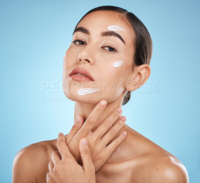 Buy stock photo Face portrait, skincare cream and woman in studio isolated on a blue background. Cosmetics, dermatology and young female model with lotion, creme or moisturizer for beauty, aesthetics and wellness.
