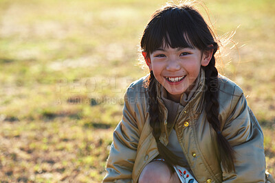 Buy stock photo Portrait, Asian girl and playing in park, smile and carefree on holiday, summer and freedom. Young person, female child and kid with happiness, play game or on field for fun, relax and break on grass