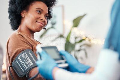 Buy stock photo Black woman, healthcare and blood pressure machine in checkup with caregiver for monitoring pulse at home. Happy African American female patient or visit from medical nurse for health and wellness