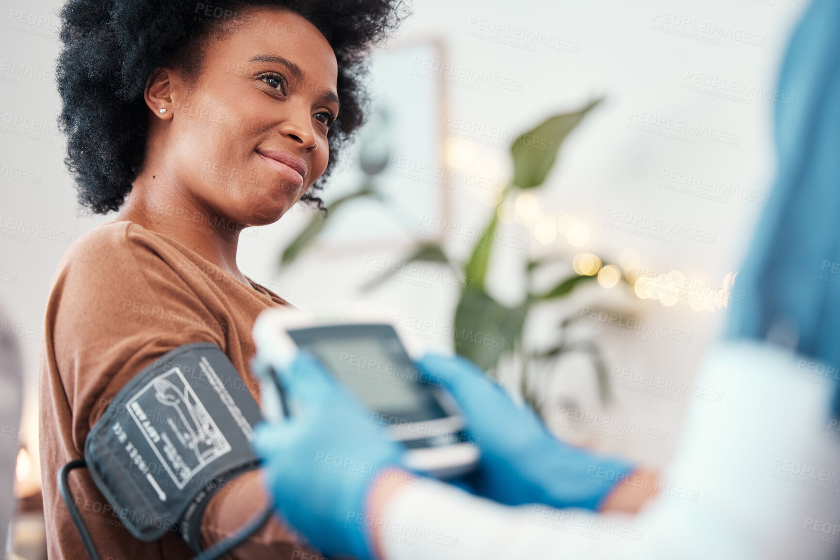 Buy stock photo Black woman, healthcare and blood pressure machine in checkup with caregiver for monitoring pulse at home. Happy African American female patient or visit from medical nurse for health and wellness