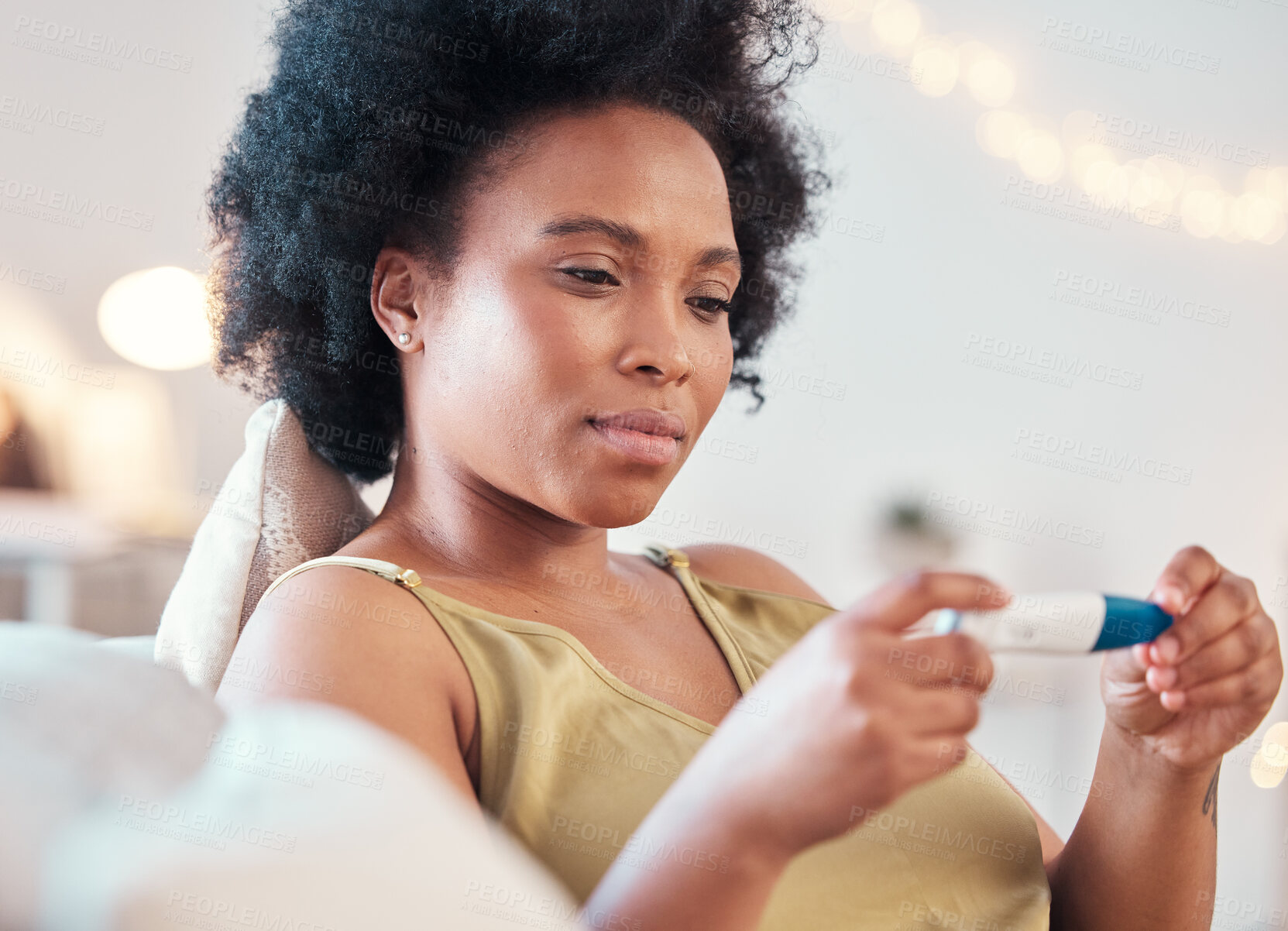 Buy stock photo Black woman, pregnancy test and confused, nervous and waiting for results on a sofa in her home. Pregnant, testing and female unsure, doubt and holding result, checking and reading in a living room