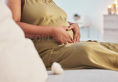 Buy stock photo Pregnant stomach, couch and black woman hands with heart hand sign feeling mother love. Mom care, sofa and living room lounge with a person holding abdomen happy about pregnancy and baby in a house