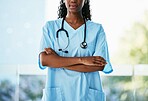 Healthcare, leadership and African doctor with crossed arms and stethoscope standing in a garden. Happy, smile and professional black woman medical worker in a medicare hospital after consultation.