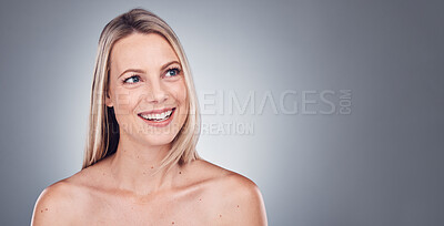 Buy stock photo Woman, thinking and skincare aesthetic with mockup in a studio for wellness and cosmetics. Facial, smile and happy model with gray background and mock up ready for dermatology and self care treatment