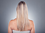 Grooming, beauty and woman with long blond hair due to salon care or cosmetic shampoo isolated in studio grey background. Treatment, balayage and girl with healthy shine and glow due to keratin