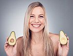 Beauty, skin or hair care avocado for woman portrait in studio with natural cosmetic and shampoo shine. Face of aesthetic model with fruit on grey background for hairdresser or sustainable product