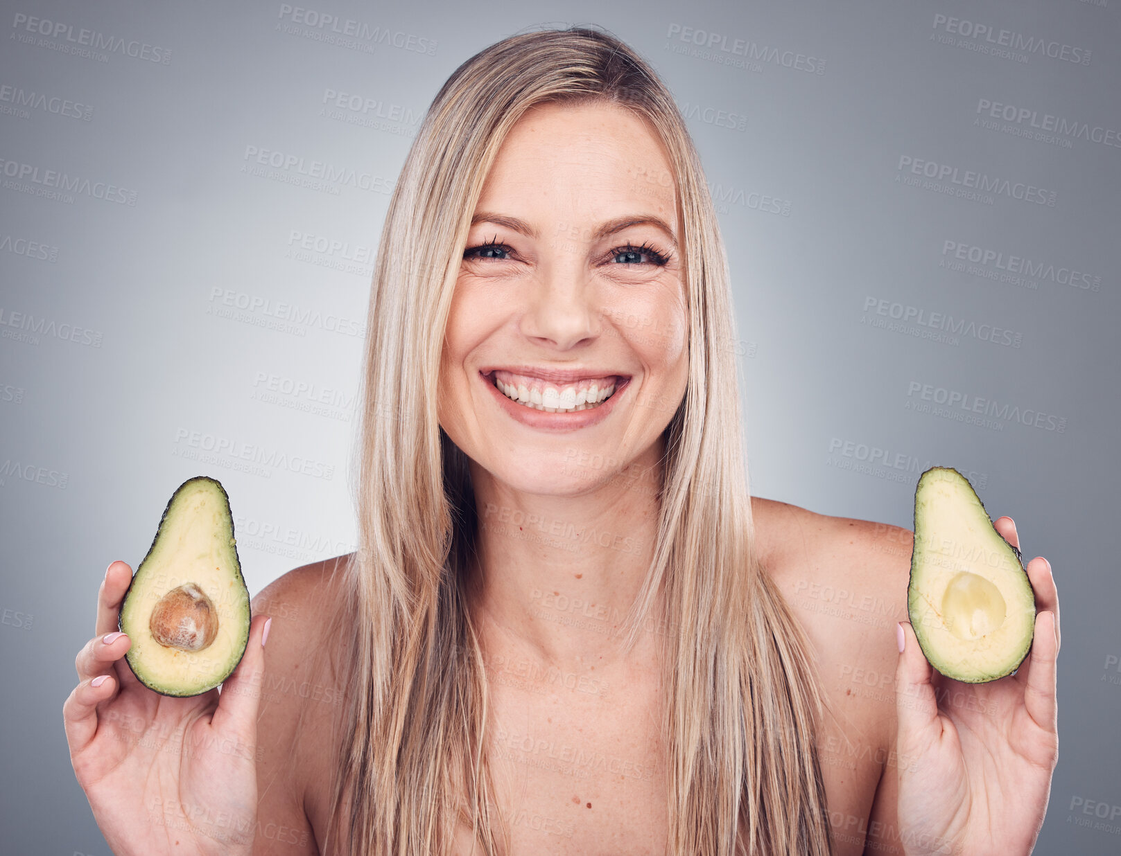 Buy stock photo Beauty, skin or hair care avocado for woman portrait in studio with natural cosmetic and shampoo shine. Face of aesthetic model with fruit on grey background for hairdresser or sustainable product