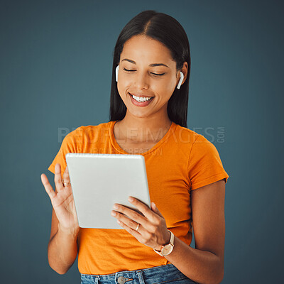 Buy stock photo Woman, tablet and listening to music online while streaming and happy on a studio background. Smile of a young gen z person with mobile app for podcast, radio or audio with network internet to relax